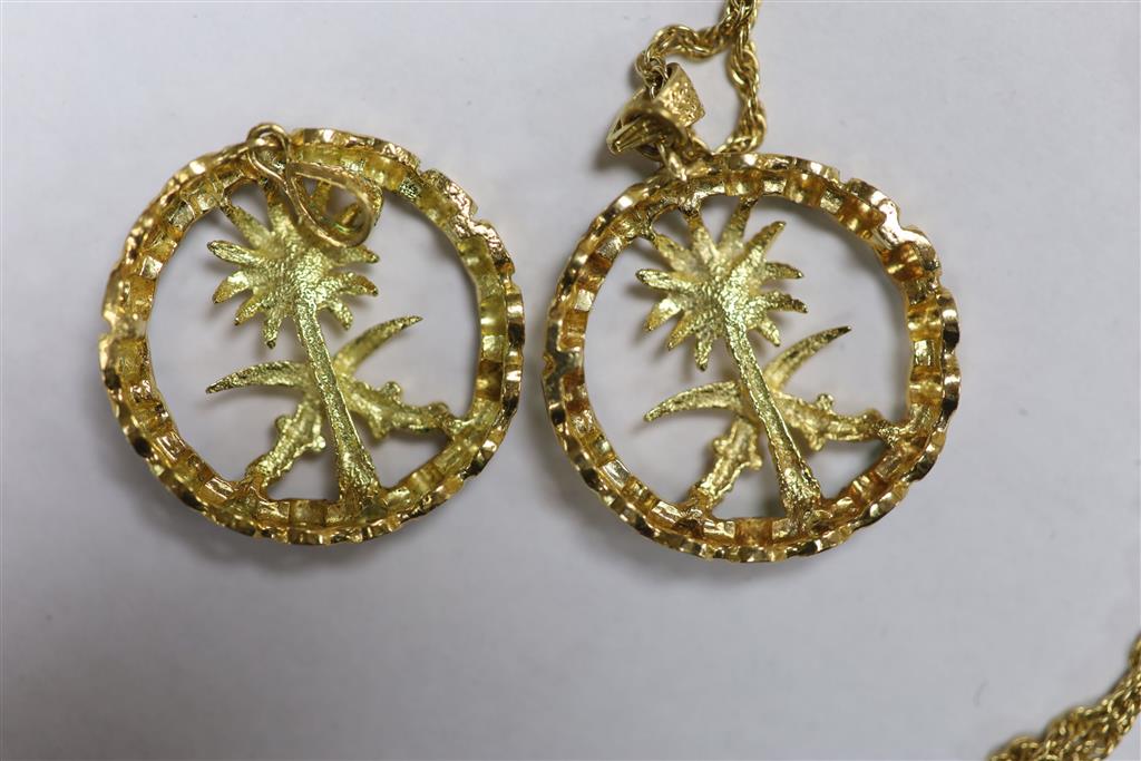 Two modern Italian 750 yellow metal and enamel Emblem of Saudi Arabia circular pendants, one with 750 chain.